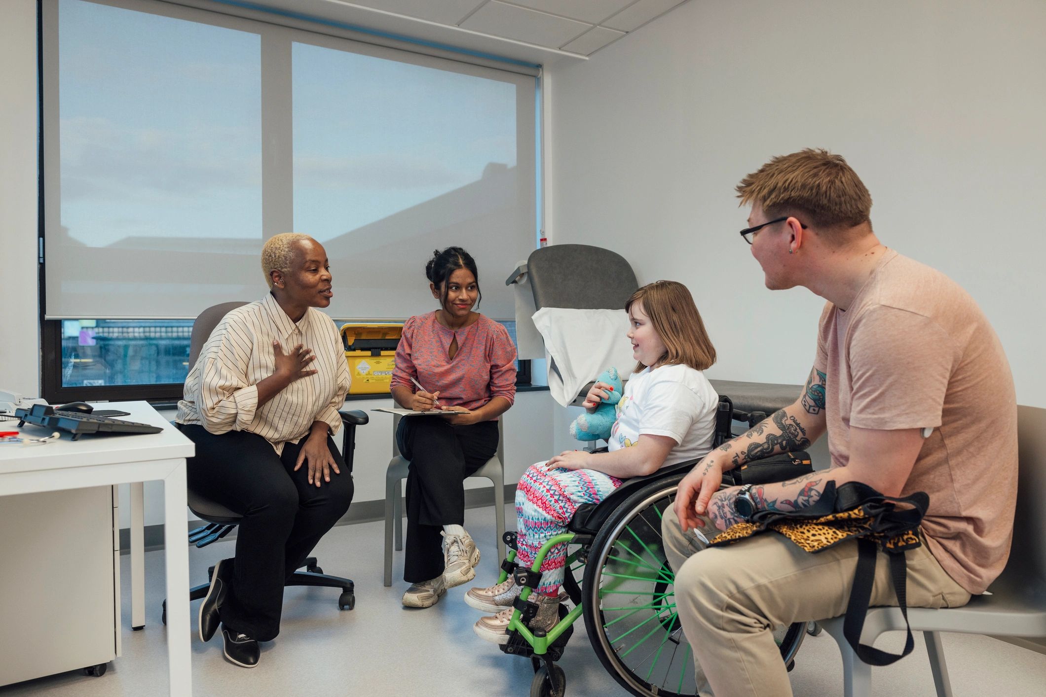 Healthcare professionals supporting a child and family during a consultation