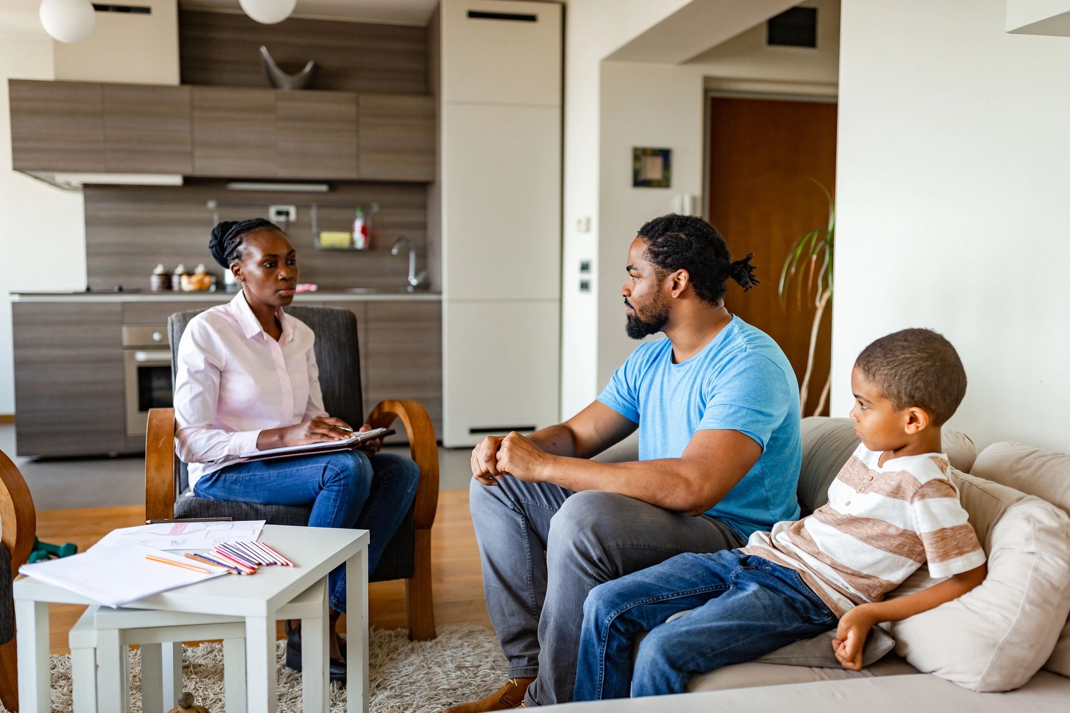 Family therapy session with therapist, father, and child