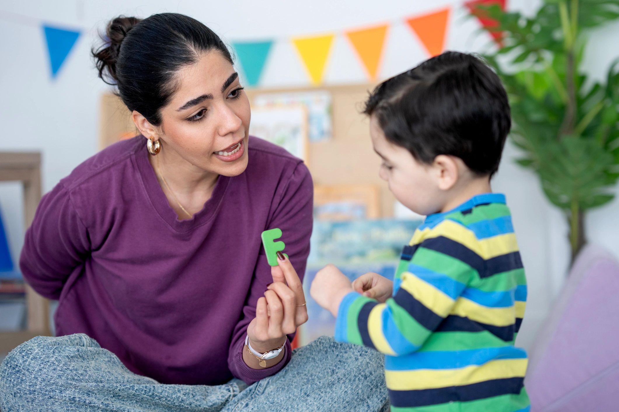 Professional guiding a child through speech and learning activities
