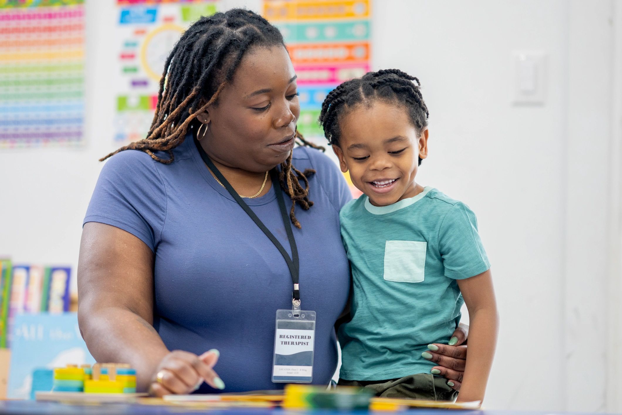 Therapist guiding a child through everyday skill-building activities