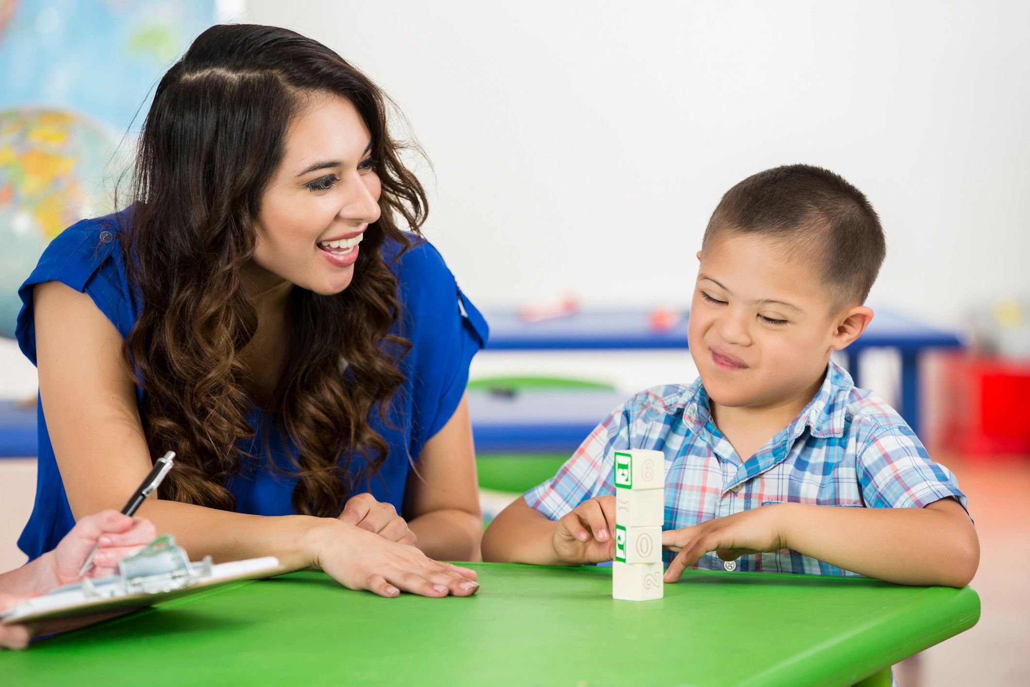 Child practicing fine motor and coordination skills during therapy support